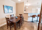 Thumbnail 5 of 22 - A dining room with a table and chairs