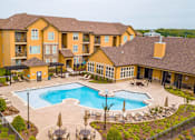 Thumbnail 18 of 22 - A large building with a pool in front.