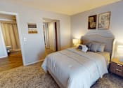Thumbnail 8 of 31 - A bedroom with a large bed and two lamps.