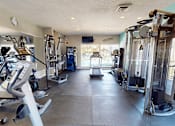 Thumbnail 16 of 31 - A gym with a variety of exercise equipment.