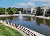 Thumbnail 28 of 31 - A fountain in the middle of a private lake with a wooden fence around it.