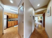 Thumbnail 2 of 14 - a view of the kitchen and living room from the hallway