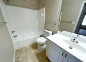 Thumbnail 7 of 21 - a bathroom with a toilet sink and bathtub