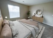 Thumbnail 6 of 21 - a bedroom with gray walls and a large window