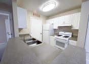 Thumbnail 3 of 21 - a kitchen with white cabinets and white appliances