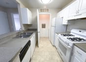 Thumbnail 4 of 21 - a kitchen with white cabinets and white appliances