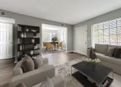 Thumbnail 3 of 11 - a living room with a couch and a table