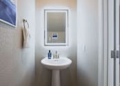 Thumbnail 36 of 93 - A bathroom with a sink and mirror.at Copper Creek Apartments, Nevada, 89123