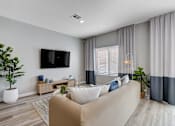 Thumbnail 27 of 93 - Living Room With TV at Copper Creek Apartments, Las Vegas