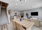 Thumbnail 32 of 93 - A modern dining room with a wooden table and chairs.at Copper Creek Apartments, Las Vegas, 89123