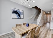 Thumbnail 40 of 93 - A dining room with a wooden table and chairs.at Copper Creek Apartments, Las Vegas