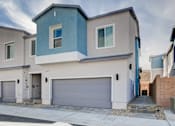 Thumbnail 44 of 93 - A modern two-story house with a garage door.at Copper Creek Apartments, Las Vegas, NV