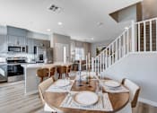 Thumbnail 59 of 93 - A modern kitchen with a dining table set at Copper Creek Apartments, Las Vegas, 89123