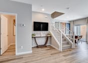 Thumbnail 55 of 93 - A living room with a staircase leading to the upper floor.at Copper Creek Apartments, Nevada