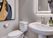 Thumbnail 70 of 93 - A white toilet and sink in a bathroom. at Copper Creek Apartments, Nevada, 89123
