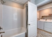 Thumbnail 83 of 93 - A white bathroom with a tub, toilet, and sink.at Copper Creek Apartments, Nevada