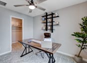 Thumbnail 86 of 93 - A room with a table, chairs, and a ceiling fan.at Copper Creek Apartments, Las Vegas, NV