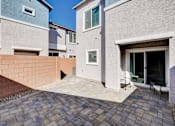Thumbnail 76 of 93 - A modern house with a brick wall and a patio.at Copper Creek Apartments, Nevada
