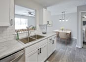 Thumbnail 8 of 39 - A kitchen with a dining table and chairs.