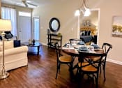 Thumbnail 7 of 20 - A dining room with a table set for six.