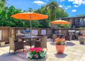 Thumbnail 3 of 20 - an outdoor patio with umbrellas and tables with chairs