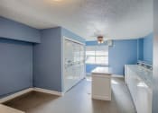 Thumbnail 15 of 20 - a blue and white kitchen with blue walls and white appliances