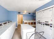 Thumbnail 16 of 20 - a laundry room with white appliances and blue walls