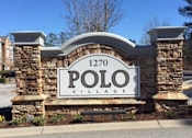 Thumbnail 13 of 21 - a sign for polo village on the side of a street