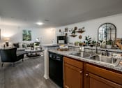 Thumbnail 1 of 23 - A kitchen with a black dishwasher and a black chair.