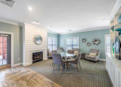 Thumbnail 7 of 24 - a dining room with a table and chairs and a fireplace