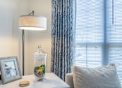 Thumbnail 16 of 24 - a corner of a room with a window and a table with a vase with