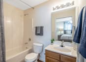 Thumbnail 22 of 24 - a bathroom with a toilet sink and tub and a mirror