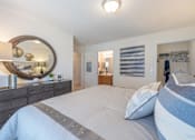 Thumbnail 15 of 24 - a bedroom with a bed and a mirror and a closet