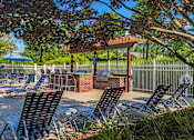 Thumbnail 3 of 29 - a patio with chairs and tables and a gazebo
