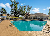 Thumbnail 1 of 29 - a swimming pool with a house in the background
