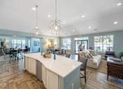 Thumbnail 7 of 29 - a large living room with a kitchen and a dining room