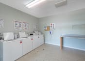 Thumbnail 12 of 29 - the laundry room is equipped with washes and dryers and a counter with a