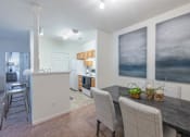 Thumbnail 15 of 29 - a kitchen and dining room with a table and chairs