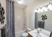 Thumbnail 20 of 29 - a bathroom with a shower and a sink and a toilet