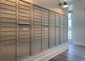 Thumbnail 20 of 42 - A row of mailboxes are lined up on a wall.