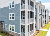 Thumbnail 26 of 42 - A row of modern townhouses with balconies and garages.