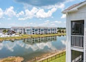 Thumbnail 25 of 42 - A building with a white exterior is reflected in a body of water.