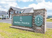 Thumbnail 35 of 42 - A sign for Anchor Pointe Apartments is displayed in front of a building.