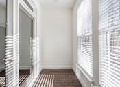 Thumbnail 48 of 52 - A hallway with white walls and striped carpeting.