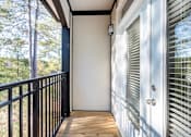 Thumbnail 50 of 52 - A balcony with a black railing and a white door with a window above it.