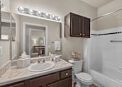 Thumbnail 10 of 19 - A bathroom with a sink, toilet, and bathtub at Heights at New Garden apartments in Greensboro, NC.