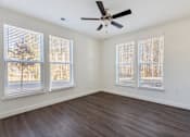 Thumbnail 38 of 52 - A room with a ceiling fan and three windows.