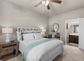 Thumbnail 9 of 19 - A bedroom with a large bed and a ceiling fan at Heights at New Garden apartments in Greensboro, NC.
