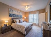 Thumbnail 20 of 21 - a bedroom with a bed and a ceiling fan