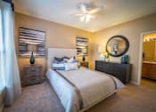 Thumbnail 19 of 21 - a bedroom with a large bed and a ceiling fan